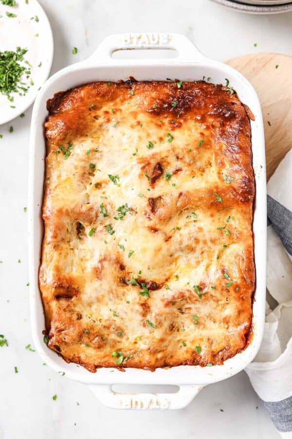 Lasagna rolls in baking dish with melted mozzarella.