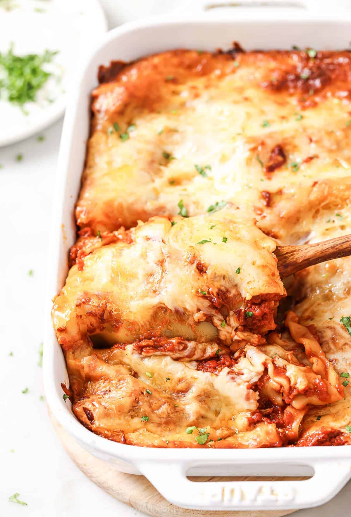 Cheesy Lasagna Rolls with Marinara Sauce in Baking Dish. 