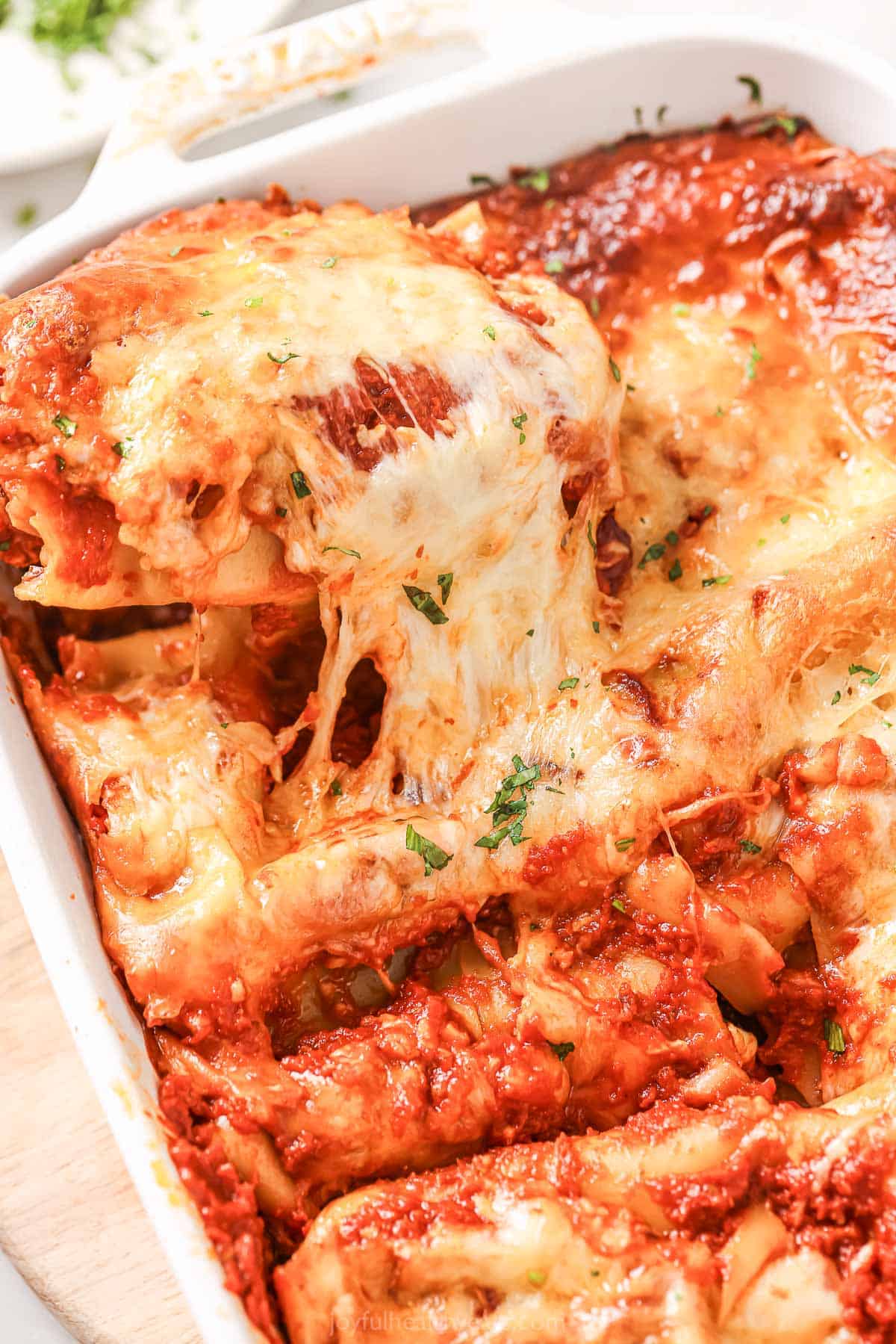 A close-up of the cheese-pulls from this melty lasagna roll with marinara sauce.