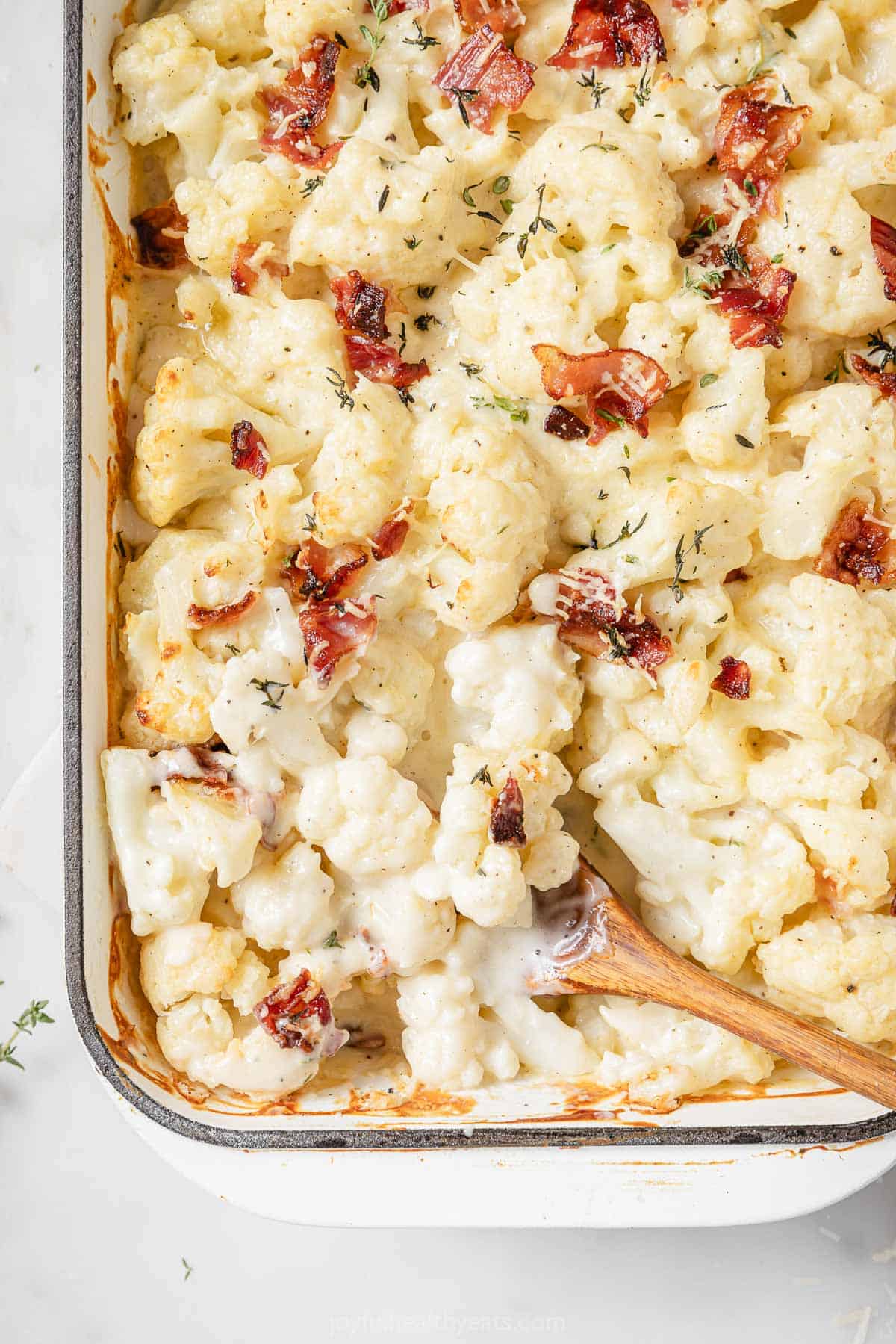 Freshly baked cheesy cauliflower au gratin with bacon. 