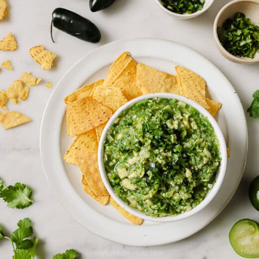 Landscape photo of avocado salsa verde with tortilla chips.