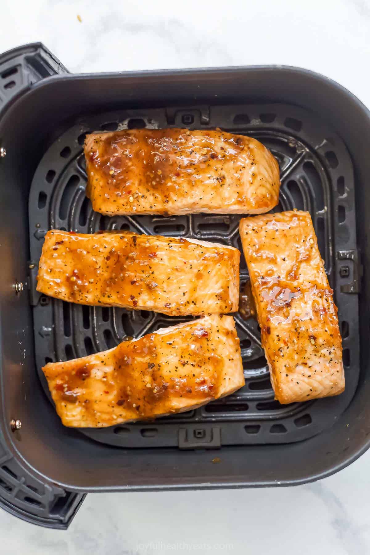 Overhead view of sweet chili salmon in air fryer