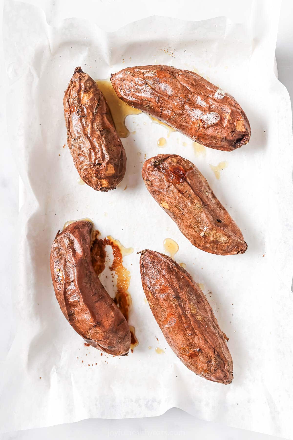 Baked sweet potatoes on  the prepared baking sheet. 