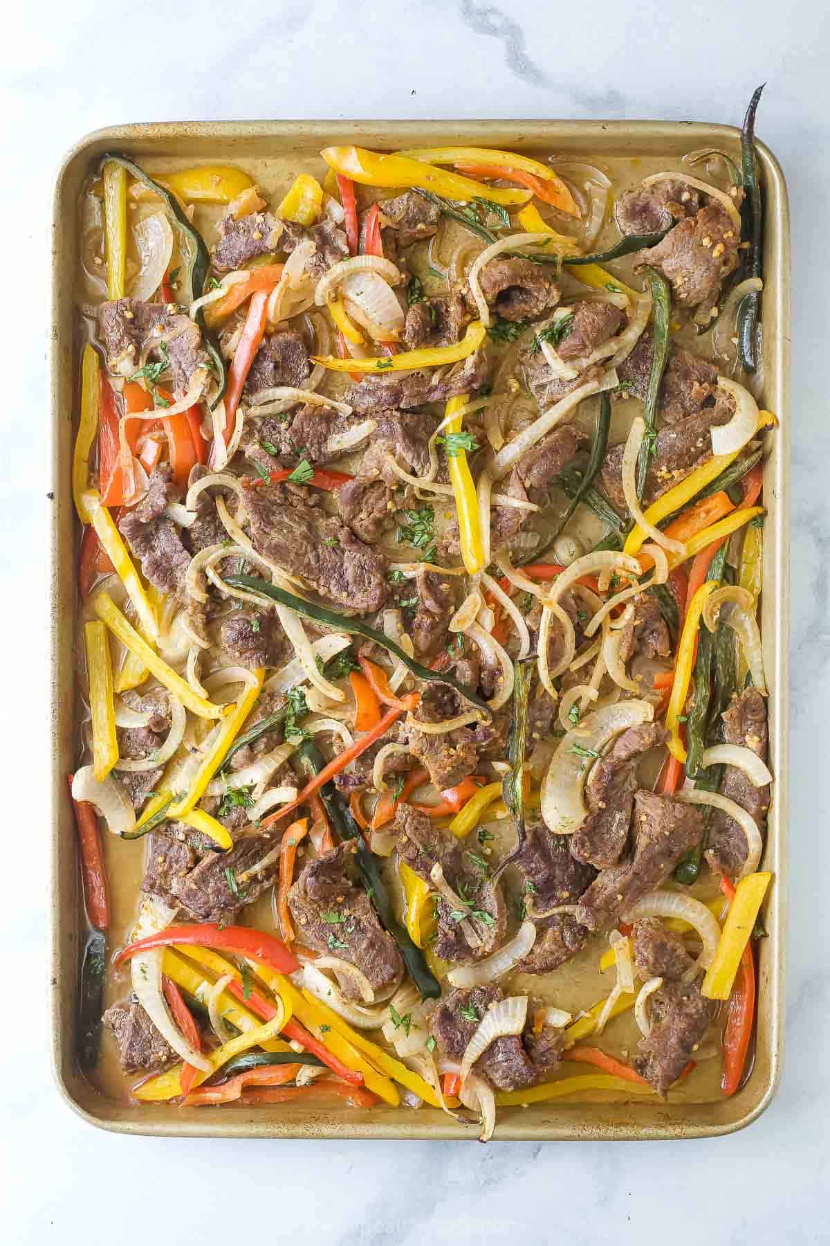 Freshly made fajitas on the baking sheet.