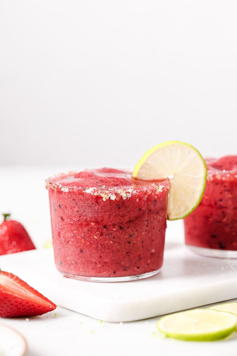 Icy berry margarita with a lime-sugar rim and a lime wedge.