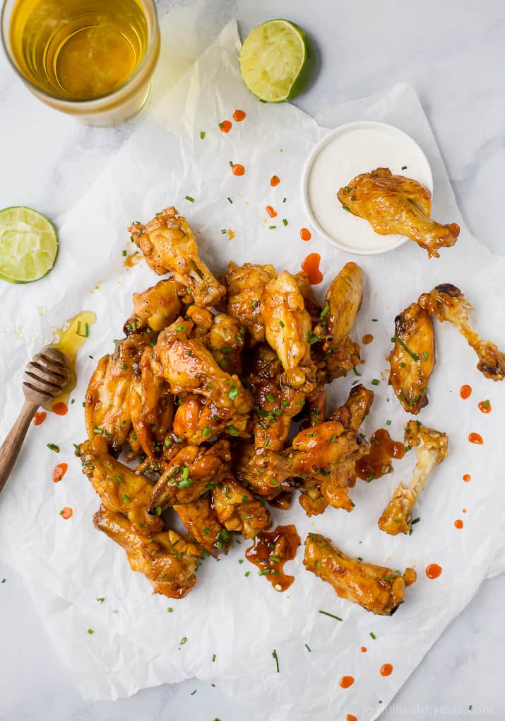 overhead photo of honey sriracha baked chicken wings with ranch