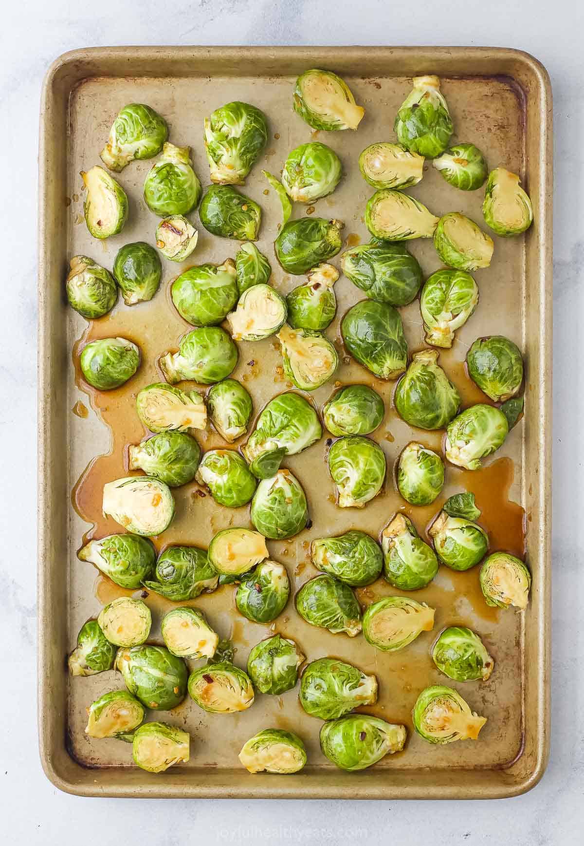 Spreading out the Brussels sprouts on the baking sheet. 