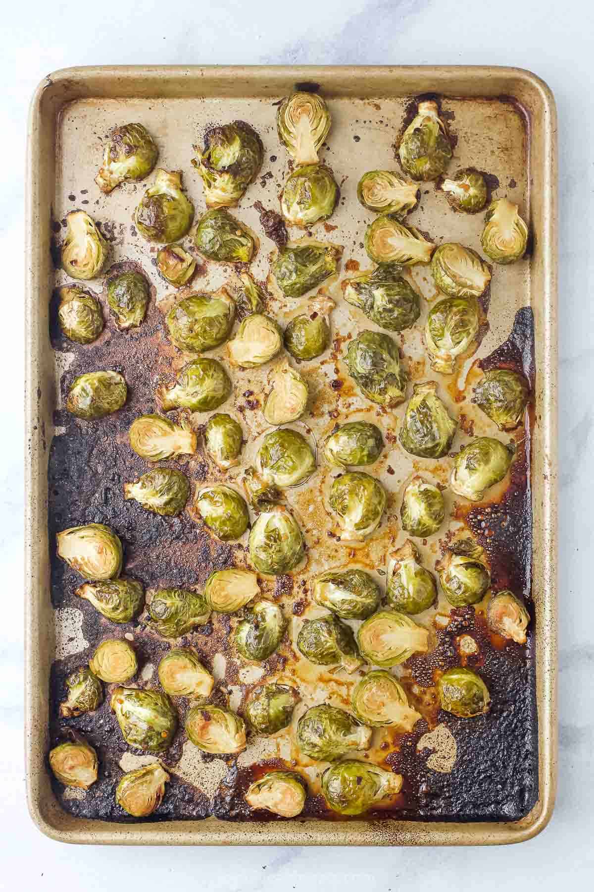 Crispy, baked Brussels sprouts in the baking sheet. 