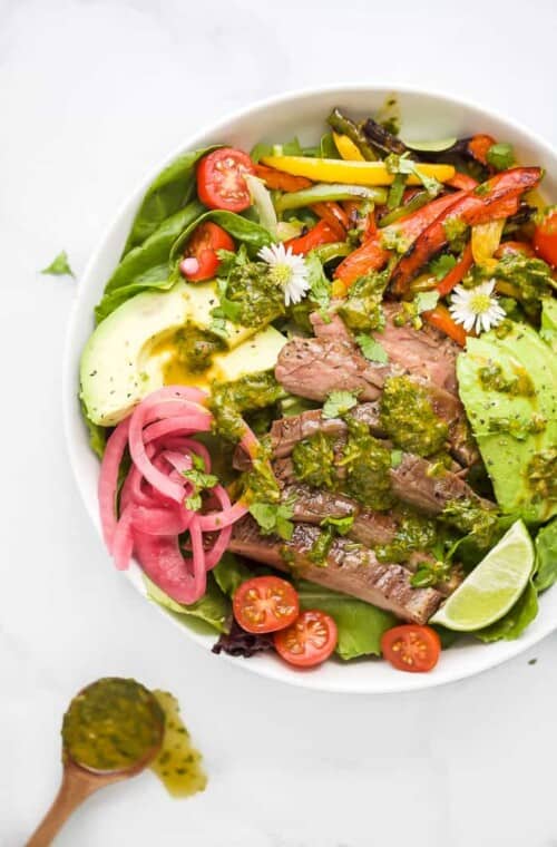 grilled fajita steak salad with chimichurri dressing in a bowl