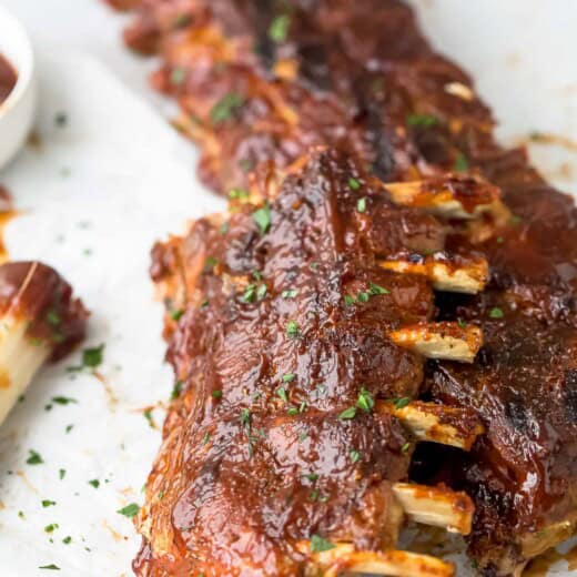 Close-up of juicy baby back ribs with BBQ glaze.