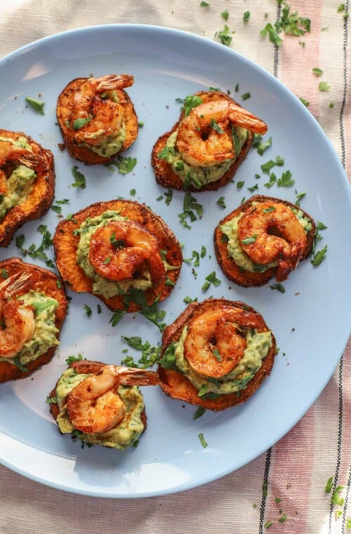 Seven shrimp appetizer bites arranged neatly on a baby blue plate