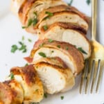 Close-up of slices of bacon wrapped chicken breast on a plate