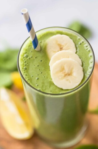 top view of a green smoothie with banana slices as garnish