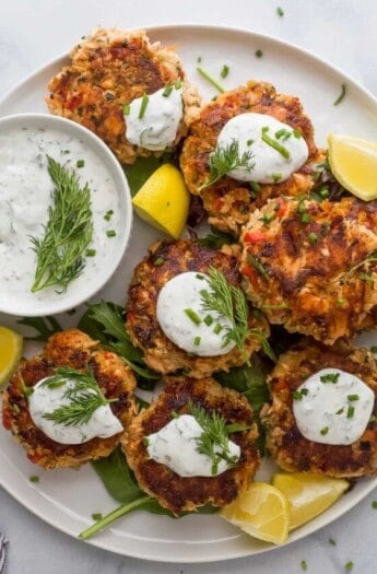 Salmon cakes with lemon dill sauce on the side.