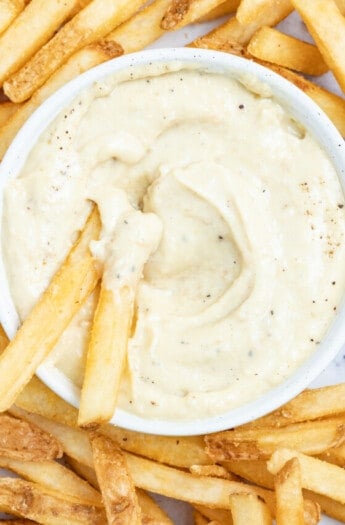 Dipping french fries into aioli.