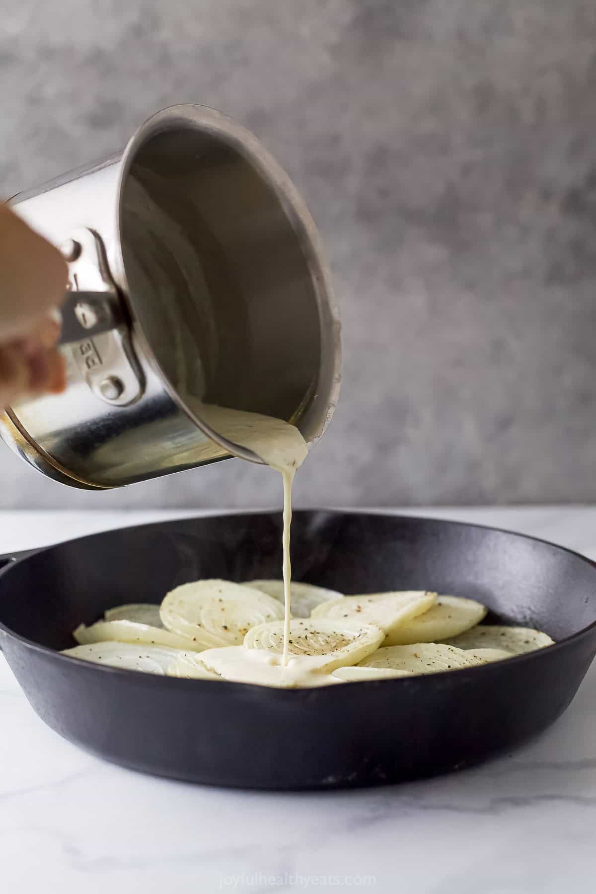 Pouring the sauce into the skillet. 