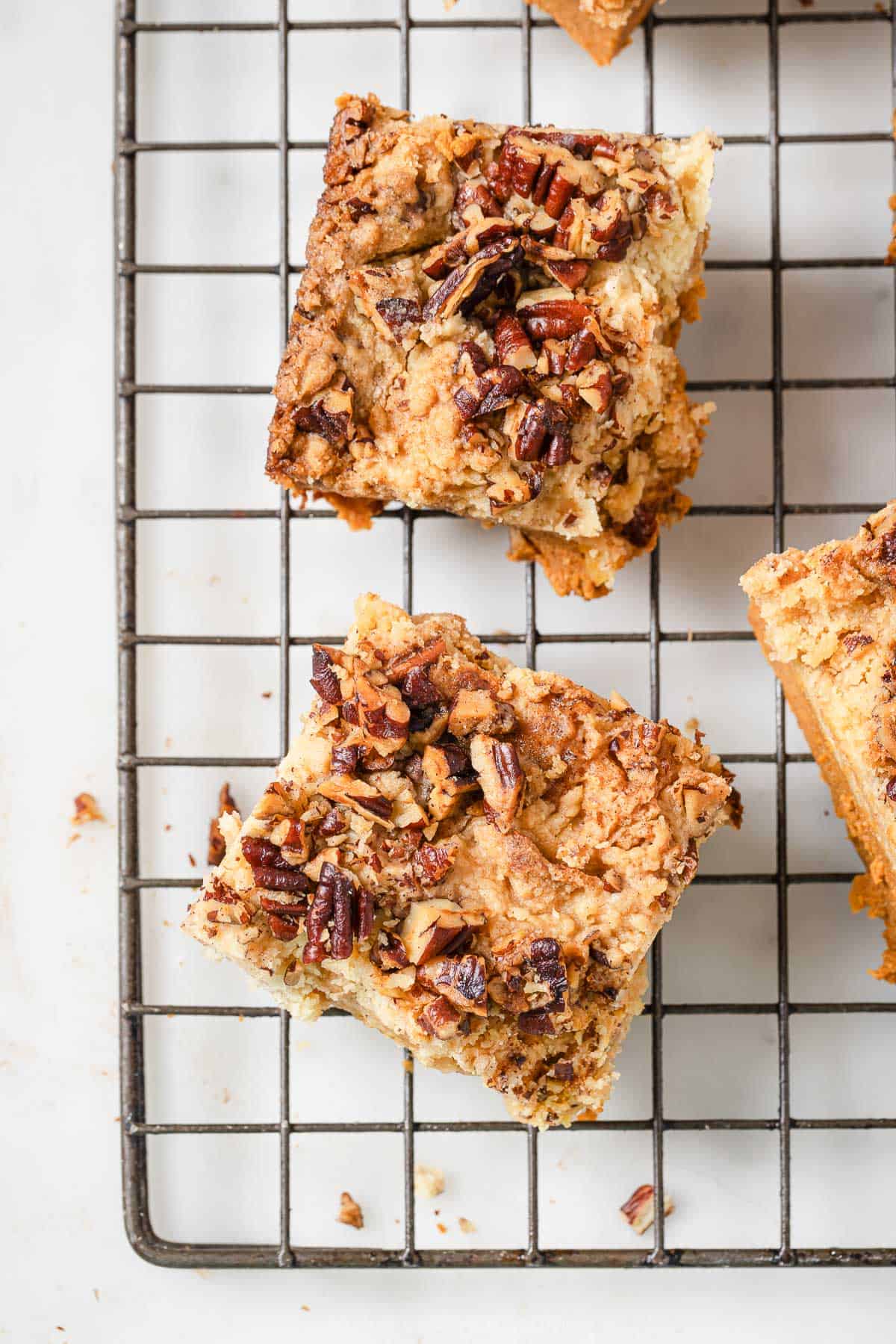 Squares of pumpkin cake  on a cooling rack.