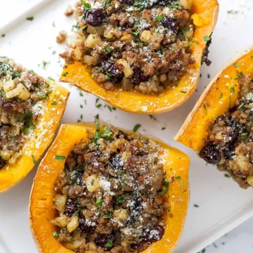 Close-up of stuffed butternut squash with juicy sausage-apple and cherry filling inside.