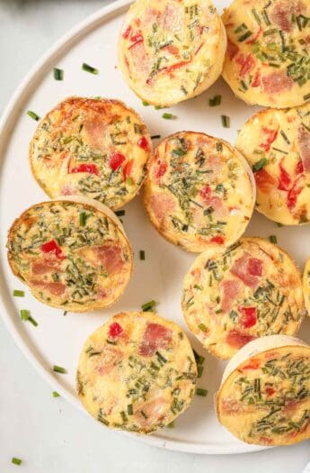 Close-up of cottage cheese egg bites with ham, roasted peppers, and crunchy chives.