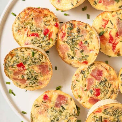 Close-up of cottage cheese egg bites with ham, roasted peppers, and crunchy chives.