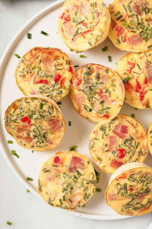 Close-up of cottage cheese egg bites with ham, roasted peppers, and crunchy chives.