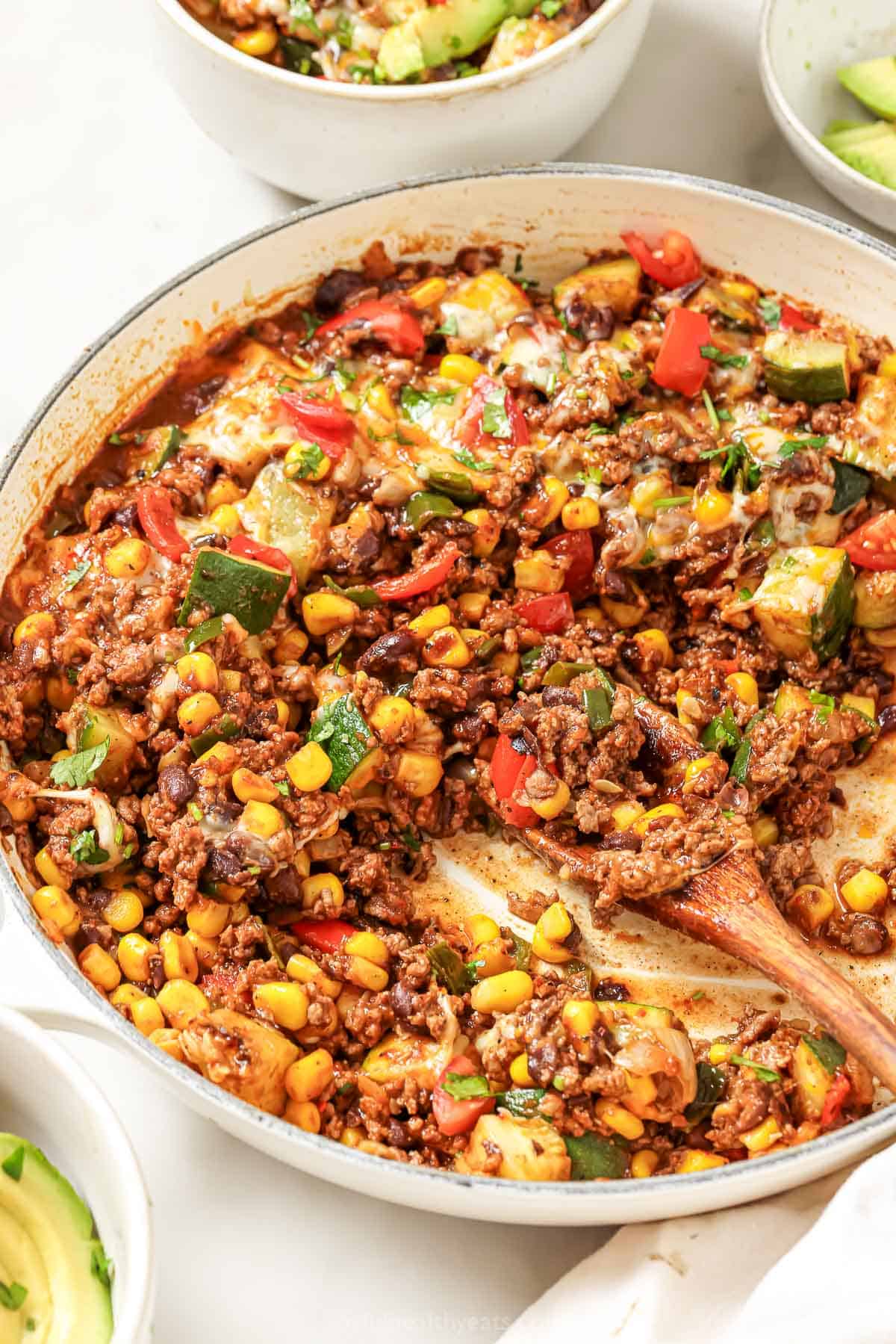 Grabbing the saucy ground beef dinner with a wooden spoon. 