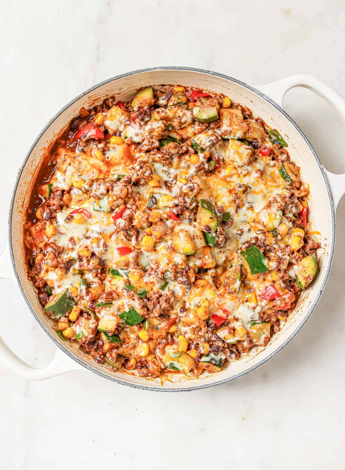 Freshly-made ground beef-and-veggie dinner with melty cheese on top. 