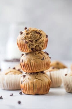 A stack of three vanilla protein muffins with chocolate chips.