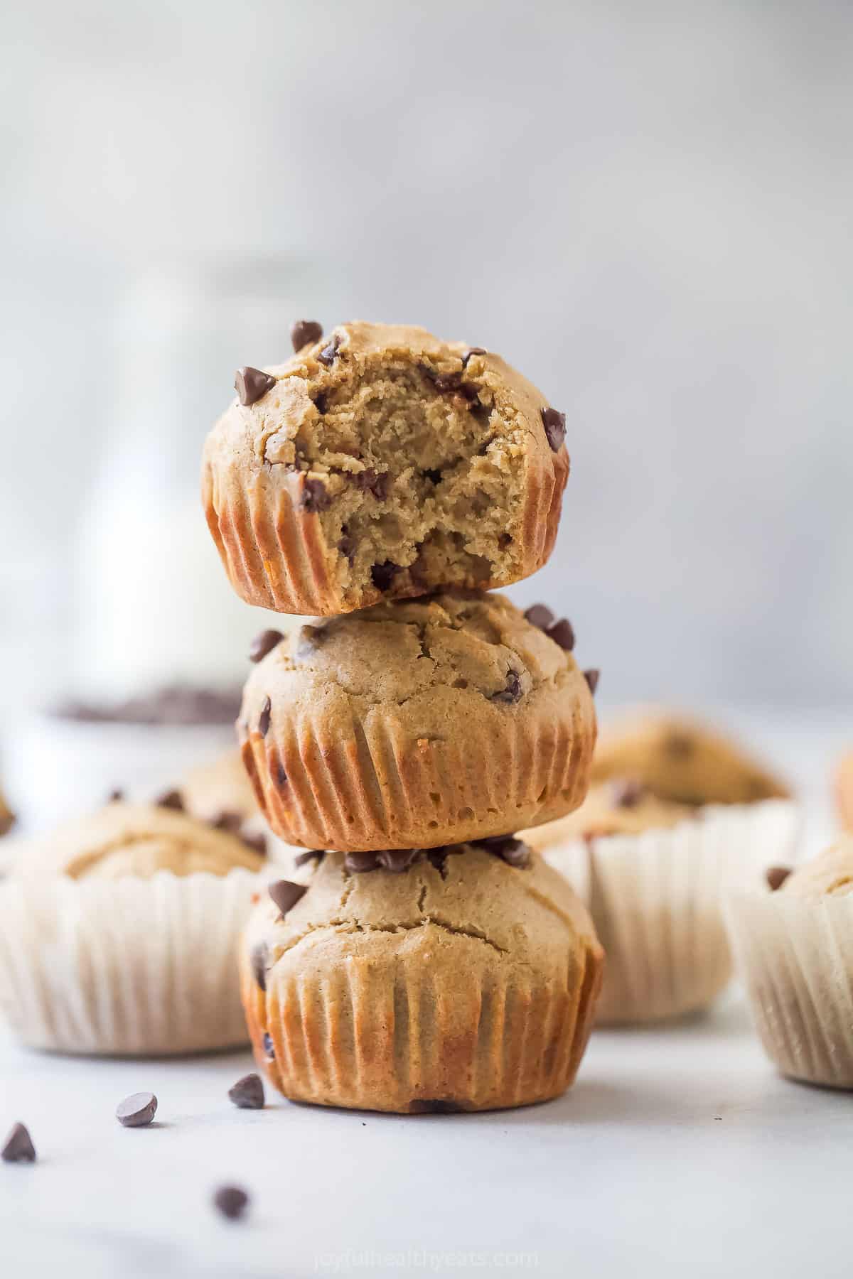 A stack of three vanilla protein muffins with chocolate chips. 