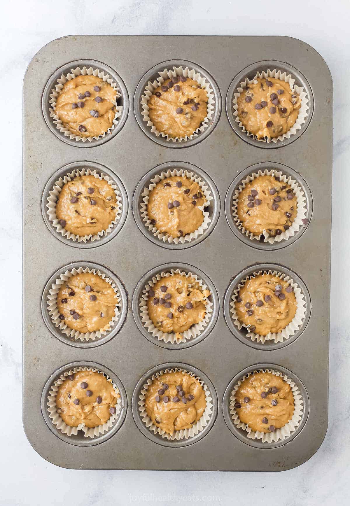 Filled liners with batter, ready to be baked. 