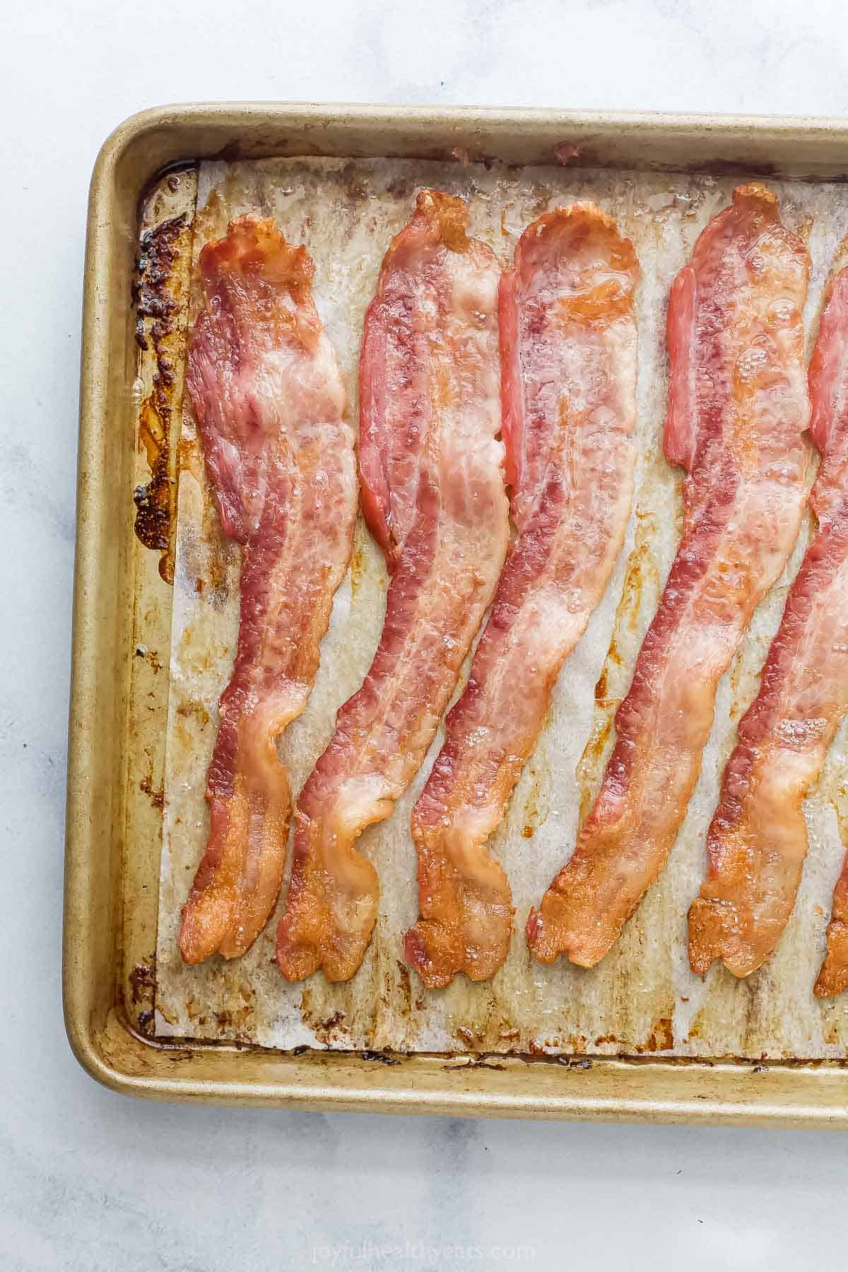 Freshly cooked bacon on the baking sheet. 