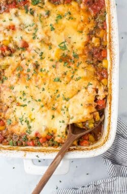 Close-up of the stuffed pepper casserole with melty cheese and fresh parsley on top.