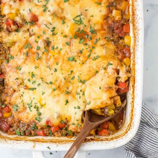 Close-up of the stuffed pepper casserole with melty cheese and fresh parsley on top.