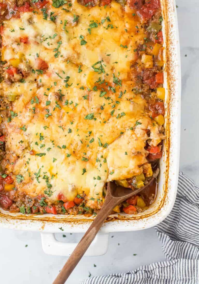 Close-up of the stuffed pepper casserole with melty cheese and fresh parsley on top.