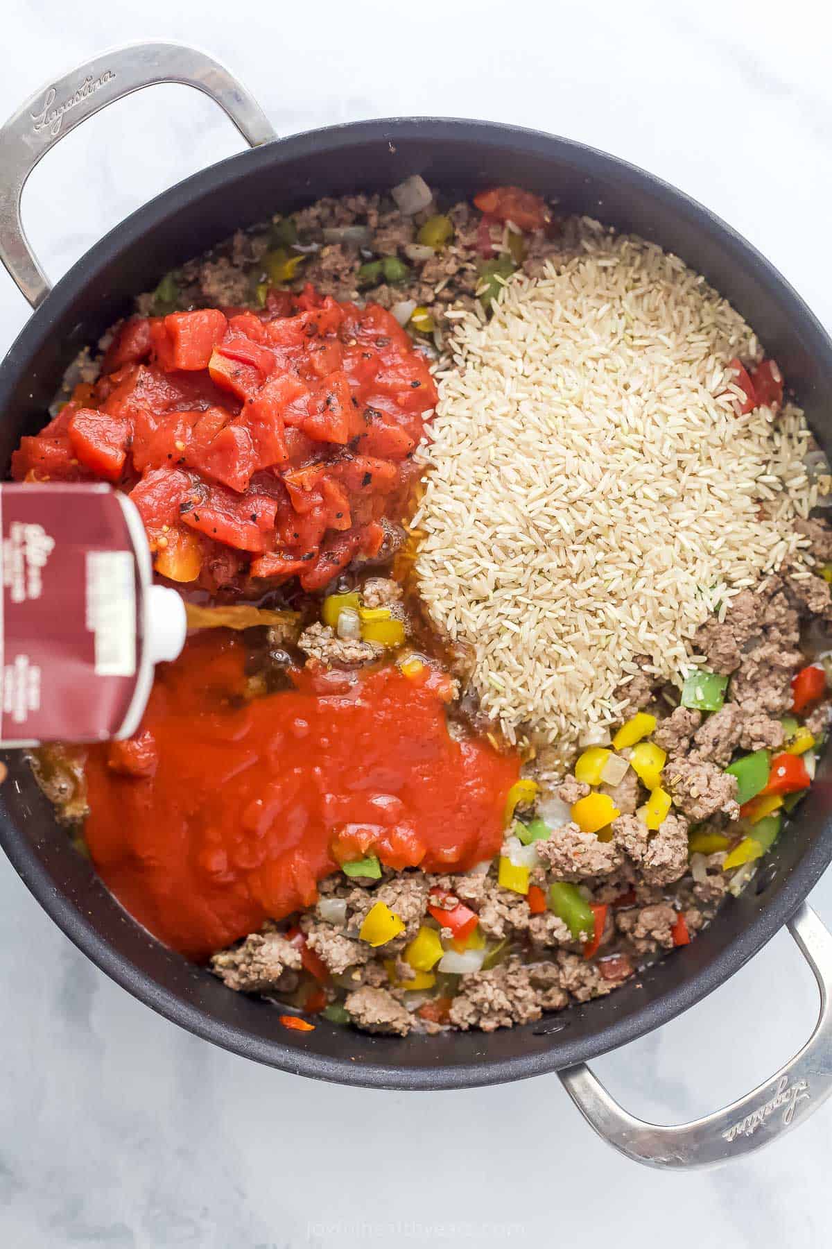 Pouring the stock into the skillet. 