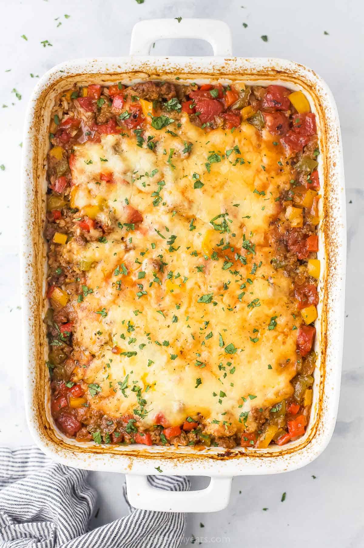 Baked beef and pepper casserole with melty cheese on top.